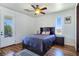 Cozy bedroom with an outdoor view and ceiling fan at 8010 Palm Cove Ct, Las Vegas, NV 89129