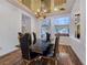 Elegant dining room with a modern chandelier and seating for six at 8010 Palm Cove Ct, Las Vegas, NV 89129