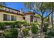 Charming home showcasing manicured landscaping, stone accents, and a decorative entryway surrounded by vibrant greenery at 8010 Palm Cove Ct, Las Vegas, NV 89129