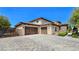 Stunning two-story home featuring a tile roof, stucco walls, stone accents, and an inviting three-car garage at 8010 Palm Cove Ct, Las Vegas, NV 89129