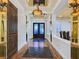 Elegant foyer features hardwood floors, mirrored accents, decorative lighting, and a striking front door at 8010 Palm Cove Ct, Las Vegas, NV 89129