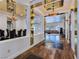 Grand foyer with mirrored walls, hardwood floors, decorative lighting, and views into the dining and living areas at 8010 Palm Cove Ct, Las Vegas, NV 89129