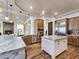 Spacious kitchen features stainless steel appliances, wood cabinets, marble countertops, and a large island with a sink at 8010 Palm Cove Ct, Las Vegas, NV 89129