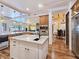 Gourmet kitchen with stainless steel appliances, custom cabinetry, marble countertops and island seating at 8010 Palm Cove Ct, Las Vegas, NV 89129