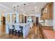 Open-concept kitchen with a large island, breakfast bar, stainless steel appliances, and wood floors at 8010 Palm Cove Ct, Las Vegas, NV 89129