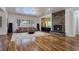 Open-concept living room showcasing hardwood floors, modern lighting, a stone fireplace, and elegant furnishings at 8010 Palm Cove Ct, Las Vegas, NV 89129