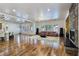 Spacious living room boasts hardwood floors, modern lighting, a stone fireplace, and access to the outdoor area at 8010 Palm Cove Ct, Las Vegas, NV 89129