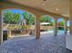 Outdoor kitchen with stone facade, built-in grill and view of pool and spa at 8010 Palm Cove Ct, Las Vegas, NV 89129