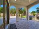 Covered patio with arched columns, stone pavers and spiral staircase at 8010 Palm Cove Ct, Las Vegas, NV 89129