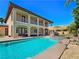 Stunning backyard oasis featuring a pool and rock slide, enhancing the home's appeal at 8010 Palm Cove Ct, Las Vegas, NV 89129