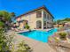 Resort-style backyard with luxurious pool and rock slide, offering the ultimate outdoor retreat at 8010 Palm Cove Ct, Las Vegas, NV 89129