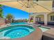 Luxurious pool and spa featuring a rock waterfall and lush landscaping, creating a serene escape at 8010 Palm Cove Ct, Las Vegas, NV 89129