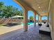 Inviting covered patio overlooking a sparkling pool and spa, perfect for outdoor relaxation at 8010 Palm Cove Ct, Las Vegas, NV 89129