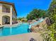 Backyard swimming pool with a rock slide, seamlessly blending fun and relaxation at 8010 Palm Cove Ct, Las Vegas, NV 89129