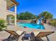 Inviting backyard pool with rock slide, creating a fun and luxurious outdoor experience at 8010 Palm Cove Ct, Las Vegas, NV 89129