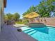 Relaxing pool and hot tub with backyard patio, offering a perfect space for outdoor entertaining at 8010 Palm Cove Ct, Las Vegas, NV 89129