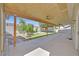 Long, covered patio and backyard with grass and gravel at 814 Singing Drum Dr, Henderson, NV 89002