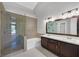 Elegant bathroom features a glass shower, soaking tub, and double sink vanity at 814 Singing Drum Dr, Henderson, NV 89002