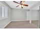 Bedroom with carpet, ceiling fan, window with shutters and closet at 814 Singing Drum Dr, Henderson, NV 89002