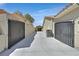 Wide driveway leading to garages, framed by gated entries providing security and curb appeal at 814 Singing Drum Dr, Henderson, NV 89002