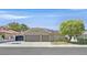 Charming single-story home with a well-manicured front yard, three-car garage and solar panels on the roof at 814 Singing Drum Dr, Henderson, NV 89002