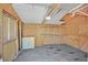 Unfinished garage featuring open stud walls, shelving, overhead lighting, and space for storage, perfect for customization at 814 Singing Drum Dr, Henderson, NV 89002