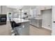 Modern kitchen with stainless steel appliances, grey and white cabinetry, an eat-in island and tile flooring at 814 Singing Drum Dr, Henderson, NV 89002