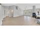 Spacious, open-concept living room with modern lighting, fireplace, tile flooring, and access to kitchen area at 814 Singing Drum Dr, Henderson, NV 89002