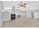 Open living room showcasing high ceilings, contemporary fireplace, adjacent to a kitchen island with seating at 814 Singing Drum Dr, Henderson, NV 89002