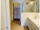 Bathroom with a step-in shower and double sink vanity and an open closet at 908 Duckhorn Ct # 102, Las Vegas, NV 89144