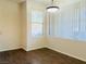 Bright dining room featuring wood floors and a contemporary light fixture at 908 Duckhorn Ct # 102, Las Vegas, NV 89144