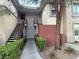 Condo exterior featuring stairs leading to upper units, complemented by green hedges and a walkway at 908 Duckhorn Ct # 102, Las Vegas, NV 89144