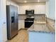 Modern kitchen with stainless steel appliances and tile flooring at 908 Duckhorn Ct # 102, Las Vegas, NV 89144