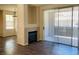 Living room featuring hardwood floors, fireplace, large sliding glass doors, and view to the balcony at 908 Duckhorn Ct # 102, Las Vegas, NV 89144