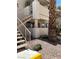 Exterior view of condo with metal stair rails and xeriscaping in a residential neighborhood at 925 Falconhead Ln # 102, Las Vegas, NV 89128