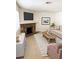 Cozy living room with stone fireplace and neutral decor offers a comfortable gathering space at 925 Falconhead Ln # 102, Las Vegas, NV 89128