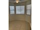 Living room with tiled floors and window with blinds for natural light at 925 Falconhead Ln # 102, Las Vegas, NV 89128