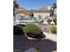 Inviting view of the community pool, and rock and shrub landscaping at 925 Falconhead Ln # 102, Las Vegas, NV 89128