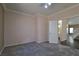 Comfortable bedroom with neutral decor, a ceiling fan, and an open doorway, creating a cozy atmosphere at 975 Leadville Meadows Dr, Henderson, NV 89052