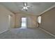 Spacious bedroom featuring neutral walls, carpet, and a ceiling fan with sliding glass doors at 975 Leadville Meadows Dr, Henderson, NV 89052