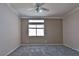 Bright bedroom with neutral walls, plush carpet, ceiling fan, and windows offering ample natural light at 975 Leadville Meadows Dr, Henderson, NV 89052