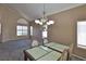 Elegant dining room with chandelier and window views at 975 Leadville Meadows Dr, Henderson, NV 89052