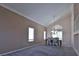 Spacious dining room with vaulted ceilings, neutral paint, plush carpet, and an elegant chandelier at 975 Leadville Meadows Dr, Henderson, NV 89052