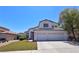 Beautiful home with a well-kept lawn, mature landscaping, and a spacious two-car garage, offering curb appeal at 975 Leadville Meadows Dr, Henderson, NV 89052