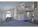 Open-concept living space showcasing a dining area, staircase, and sleek flooring transitions for modern living at 975 Leadville Meadows Dr, Henderson, NV 89052