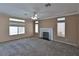 Spacious living room featuring a fireplace, fan, and large windows at 975 Leadville Meadows Dr, Henderson, NV 89052