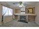 Cozy living room featuring a fireplace, large window, and neutral decor at 975 Leadville Meadows Dr, Henderson, NV 89052