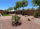 Backyard featuring desert landscaping with pavers, artificial turf, and rock ground cover at 9853 Russian Hill St, Las Vegas, NV 89141