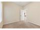 Neutral bedroom with carpet flooring, a window, and a paneled door at 9853 Russian Hill St, Las Vegas, NV 89141