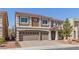 Inviting two-story home featuring a three-car garage and a landscaped front yard at 9853 Russian Hill St, Las Vegas, NV 89141